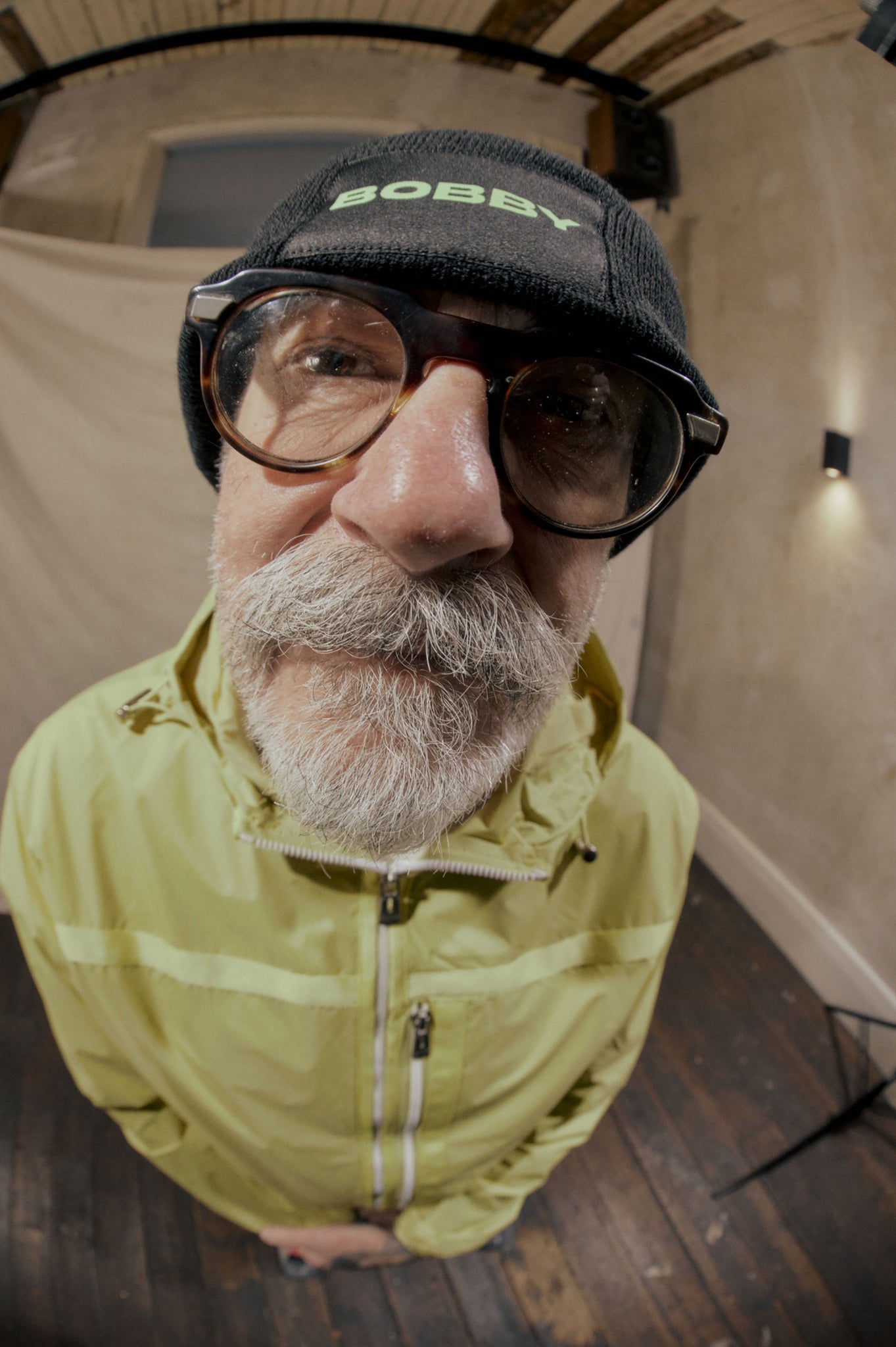 fisheye photography of an older man showing off his new winter accessories