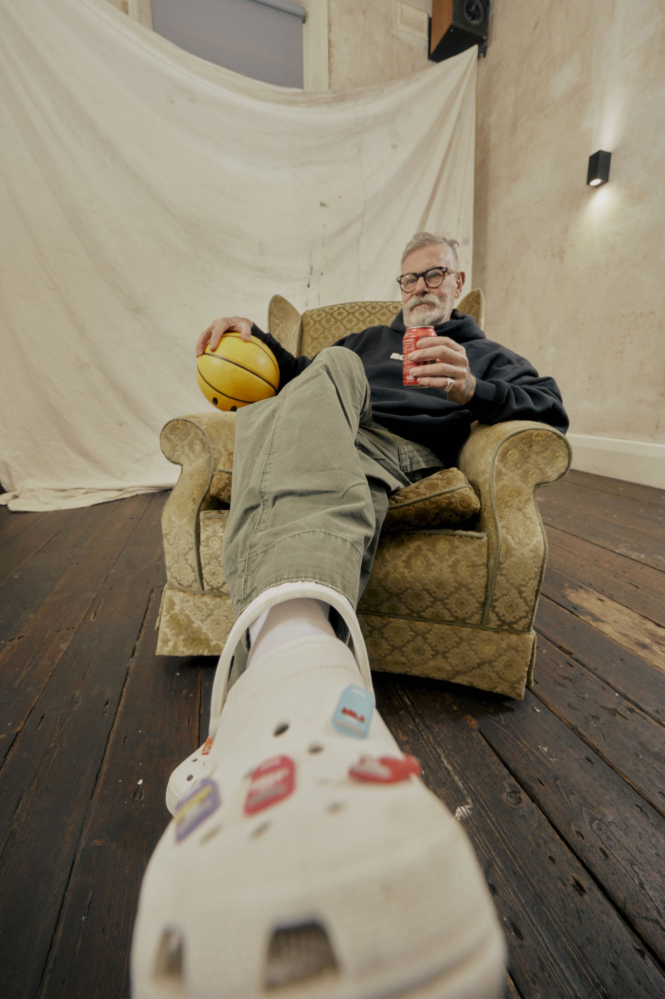 fisheye lens shot of old gentleman relaxing and enjoying a cold beverage 